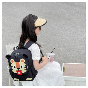 Detail of cute tiger pattern backpack on a child with functional side mesh pockets