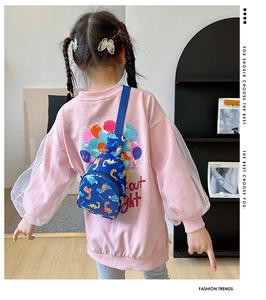 Toddler cartoon dinosaur chest bag in navy blue shown on a young girl in a casual setting
