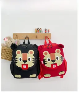 Detail view of cartoon tiger backpack featuring 3D ears, whiskers, and mesh side pockets