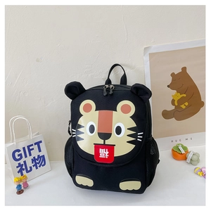Detail of cute tiger pattern with red flap and side mesh pocket on kids black backpack