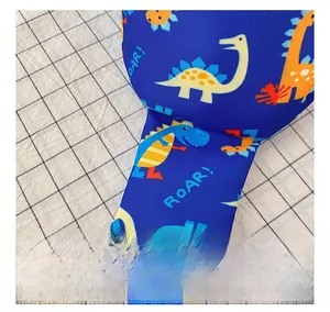 Detail showing blue dinosaur print fabric with high-quality twill weaving texture