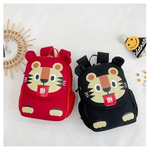 Detail of red and black tiger-themed backpacks with 3D ears and side mesh pockets