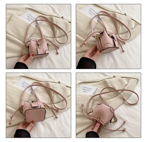 Detailed views of a pink mini drawstring bucket bag with lychee texture and shoulder strap