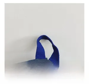 Close-up of the durable blue woven handle and classic denim fabric on children backpack