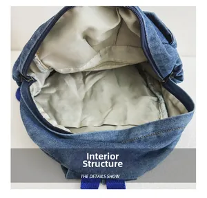 Internal structure of denim backpack featuring spacious main compartment and zipper pocket