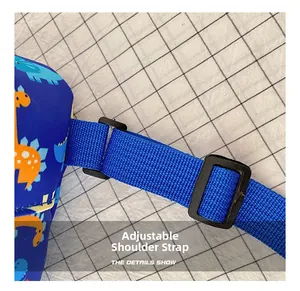 Detail showing adjustable shoulder strap buckle on cartoon dinosaur children's sling bag