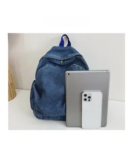Detailed size comparison of the denim backpack with a tablet and mobile phone