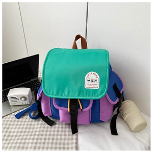 Detail view of colorful kindergarten backpack with teddy bear patch and buckle closure