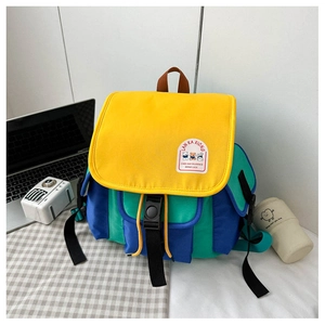 Close-up of a colorful canvas backpack for kids with bear patch and buckle detail