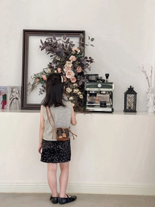 Girl wearing a brown monogram mini bucket bag with a tweed top and sequined skirt