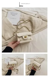 Dettaglio mini borsa trapuntata bianca con chiusura girevole dorata e tracolla a catena