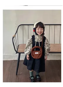 Detail display of a brown crochet knit mini bag paired with a vintage autumn outfit