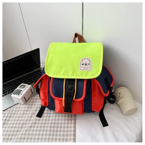 Detail of color-block canvas kids backpack with front buckle and drawstring closure
