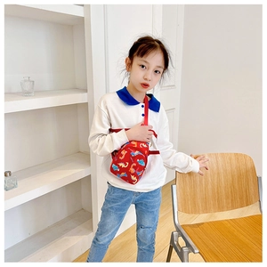 Toddler girl wearing a red cartoon dinosaur crossbody bag made of durable nylon material