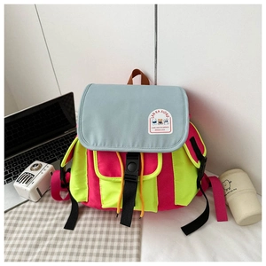 Close-up of colorful canvas backpack with buckle closure and cute bear patch detail