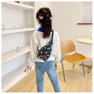 Detailed back view of kids cartoon dinosaur crossbody bag with adjustable blue strap