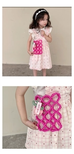 Detail of pink beaded hollow-out bag for girls with strawberry charm and pearl strap