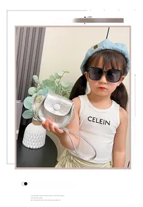 Close-up of a silver crocodile pattern mini crossbody bag for kids with button closure