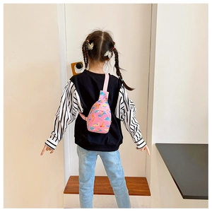 Pink cartoon dinosaur chest bag shown on child's back for size reference and daily use