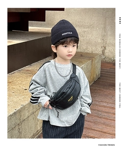 Détail du sac banane noir pour enfant avec lettrage jaune sur un mannequin stylé