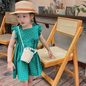 Girl's green polka dot summer dress with ruffle sleeves and pearl bucket handbag