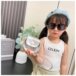 Detail of silver crocodile-embossed mini shoulder bag for kids with white round button clasp