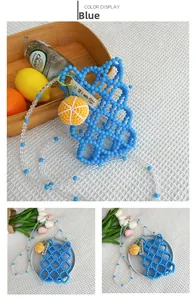 Detail of blue beaded girls handbag with knitted orange charm and mesh texture