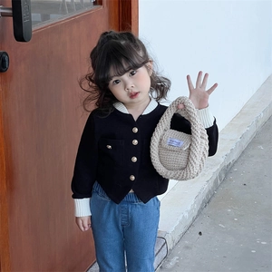 Toddler knitted cardigan and jeans outfit with beige handmade woven handbag