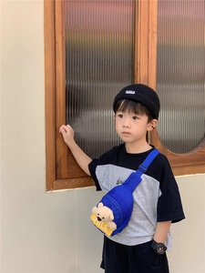 Blue canvas kids chest bag featuring a plush bear accessory and yellow SMILE label