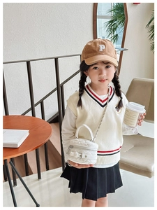 Mini white quilted crossbody bag with silver chain and buckle detail for children