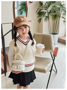 Girl's outfit set featuring a white quilted mini crossbody bag and corduroy baseball cap