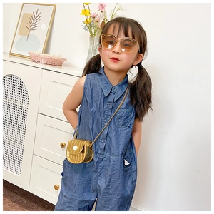 Golden mini faux crocodile texture handbag styled with kids denim outfit and sunglasses