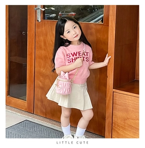 Detail view of pink quilted mini handbag with ruffle design for young girls
