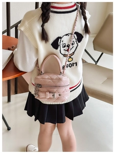 Detail of pink quilted mini bag with pearl top handle and metallic chain strap