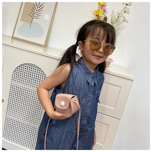 Detailed view of kids' pink crocodile-pattern mini crossbody bag with a flap closure