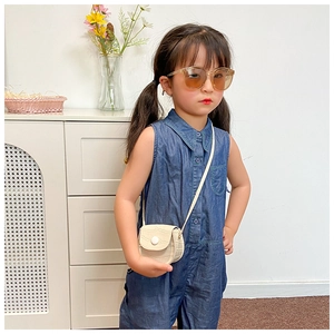 Detail of a mini cream PU crossbody bag for girls with elegant crocodile pattern texture
