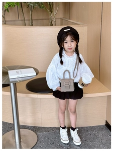 Kids khaki litchi grain mini saddle bag paired with white shirt and black skirt outfit
