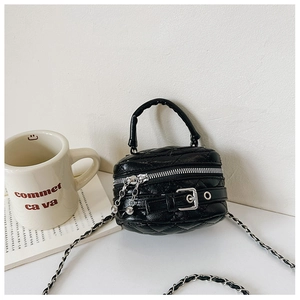Detailed close-up of a mini black quilted handbag with silver hardware and chain strap