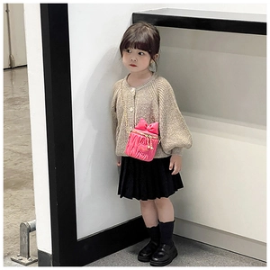 Pink child's bucket bag featuring bow detail and heart quilting on a golden chain strap