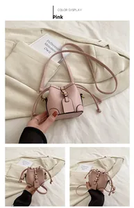 Detailed view of pink mini leather bucket bag with metal buckle and drawstring closure