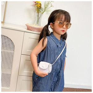 Detail of white crocodile pattern mini bag and sunglasses for toddler fashion