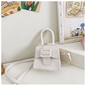Close-up of a white lychee grain mini saddle bag with horse buckle and detachable strap