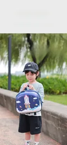 Toddler in outdoor park wearing a deep blue rocket hard-shell backpack for space exploration