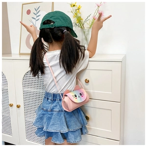 Detailed back view of a girl wearing the pink cat crossbody bag with rainbow finish