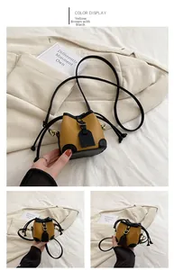 Detailed view of mini bucket bag in yellow-brown and black with leather drawstring