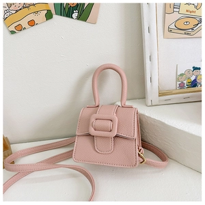 Detail of pink lychee texture mini saddle bag with decorative buckle for girls