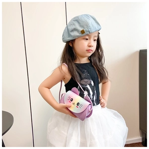 Toddler girl wearing a purple crossbody bag with rainbow sequin cat ears and details