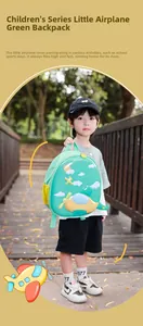 Close-up of green kids backpack with cartoon airplane and yellow mesh side pocket