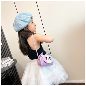 Girl wearing a purple rainbow cat crossbody bag with cute 3D ears and colorful flap