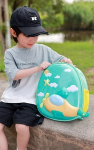Macro detail of toddler airplane hardshell backpack featuring 3D cartoon motifs and side mesh pocket